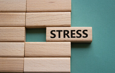 Stress symbol. Concept word Stress on wooden blocks. Beautiful grey green background. Medicine and Stress concept. Copy space.