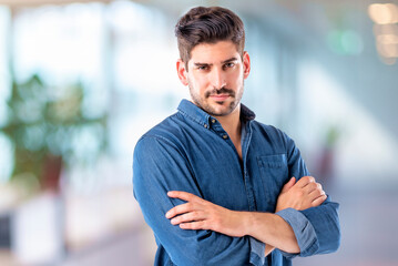 Portrait of confident mid aged man standing inside