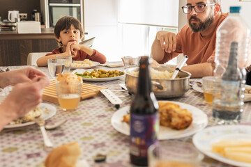 Child eating at home with his family