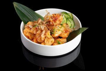 Japanese shrimps salad Ebi salad in bowl on a black background with reflection.