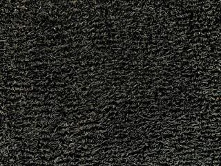 PVC coil floor mat closeup, a texture for background. Black vinyl loop mat for car floor, or...