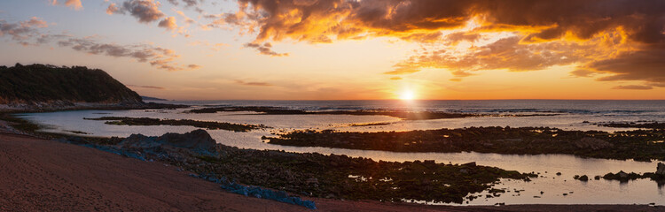 Fototapeta premium Sunset ocean coast view from beach (near Saint-Jean-de-Luz, France, Bay of Biscay). Panorama.