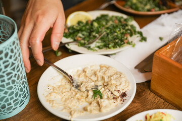 hands eagerly grab and devour food, representing hunger, sustenance, and the primal instinct of satisfying one's appetite
