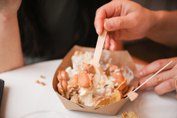 hands eagerly grab and devour food, representing hunger, sustenance, and the primal instinct of...