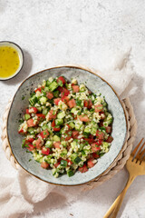 Tabbouleh salad. Traditional middle eastern or arab dish. Levantine vegetarian salad with parsley, mint, bulgur, tomato.