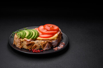 Delicious nutritious grilled toast with ham, cheese, tomatoes and avocado