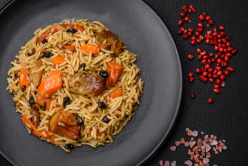 Delicious fresh pilaf with rice, carrots, meat, onions, spices and berries