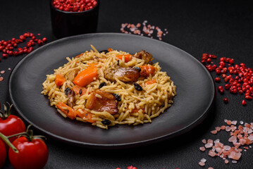 Delicious fresh pilaf with rice, carrots, meat, onions, spices and berries