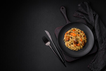 Delicious fresh pilaf with rice, carrots, meat, onions, spices and berries