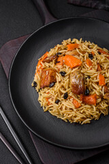 Delicious fresh pilaf with rice, carrots, meat, onions, spices and berries