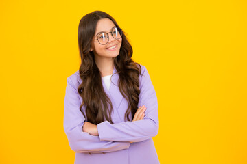 Obraz premium Portrait of young teenage girl standing with crossed arms against yellow background with copy space.