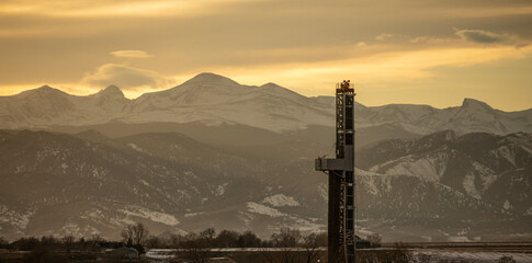Oil Rig with Mountains During Sunset