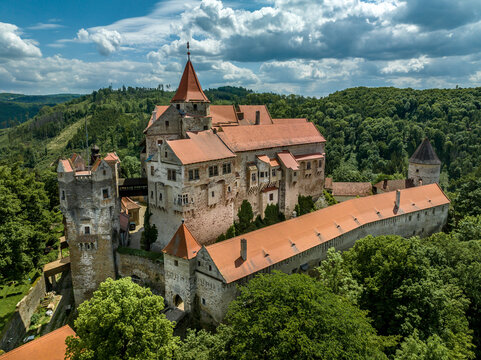 Aerial view of Pernstejn castle with Gothic palace red roof, rectangular and round towers, barbican, forward gun platform in Moravia