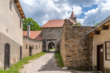 Fototapeta na wymiar Aerial view of Pernstejn castle with defensive barbican with two levels of loopholes and a narrow corridor to protect the outpost tower