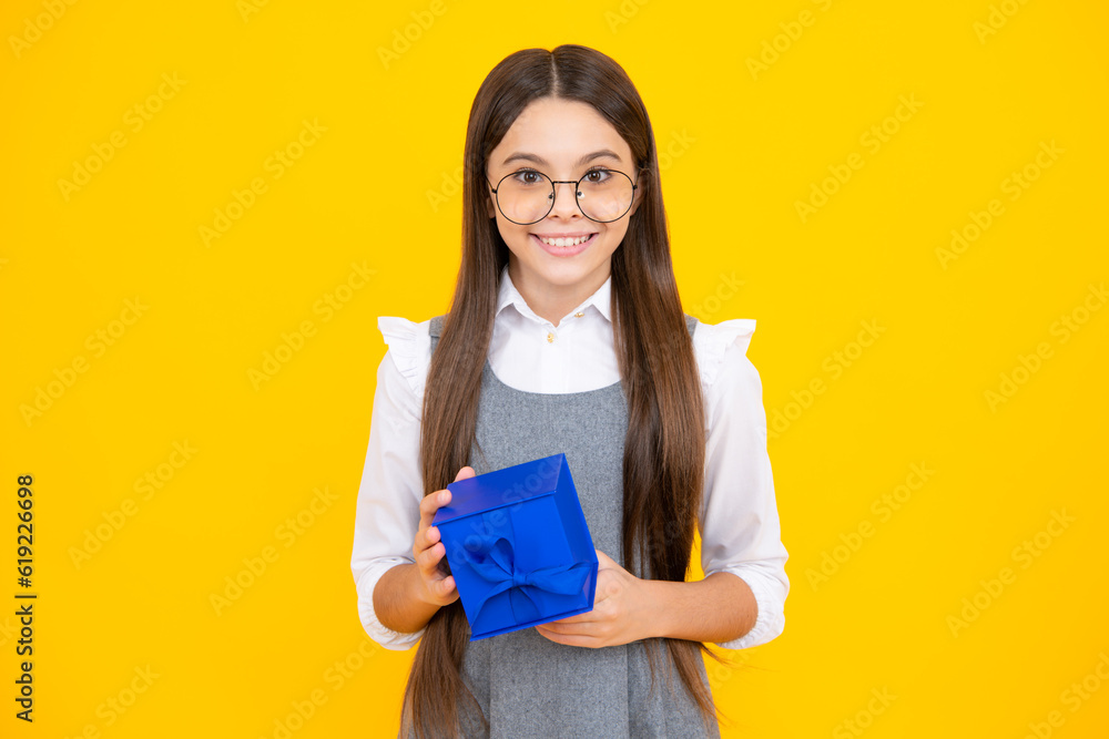 Wall mural emotional teenager child hold gift on birthday. funny kid girl holding gift boxes celebrating happy 