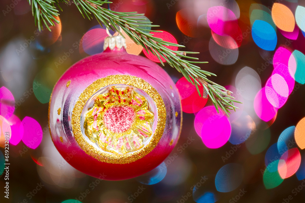 Aufkleber christmas tree decorated red ball toy, fir branch with balls and festive lights on the christmas bac