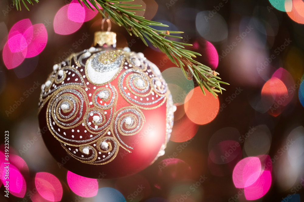 Aufkleber christmas tree decorated red ball toy, fir branch with balls and festive lights on the christmas bac