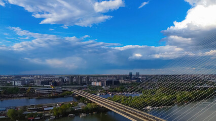 Obraz premium Belgrade, Serbia - April 15th 2023 aerial photo from above of New Belgrade district across the Ada Bridge on a cloudy day
