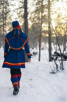 Unrecognizable indigenous person in gakti and nutukas in winter woodland