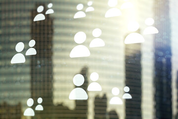 Double exposure of abstract virtual social network icons on modern skyscrapers background. Marketing and promotion concept