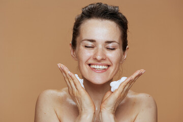 smiling modern 40 years old woman washing face