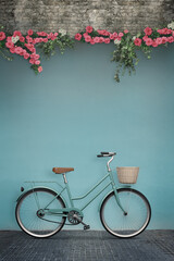 Classic vintage bicycle and wall with flowers