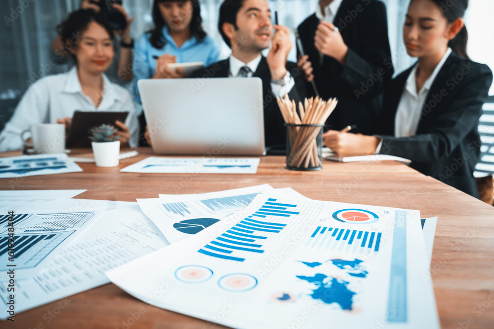 Aufkleber piles of analyzed financial data dashboard on meeting table with background of business people analy