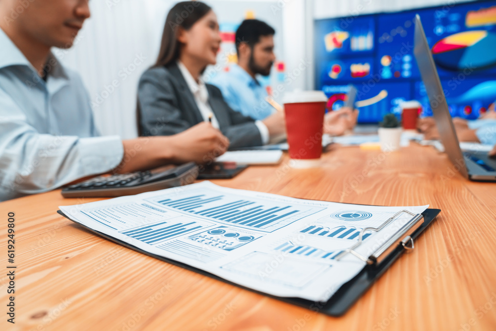 Poster focus financial dashboard paper showing graphs and chart with blurred background of diverse business