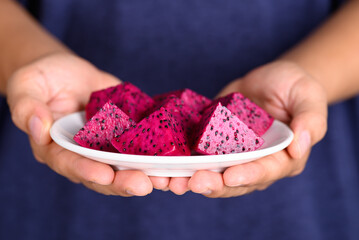 Sliced red dragon fruit or pitaya with hand ready to eating, Tropical fruit in summer season
