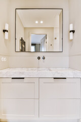 Fototapeta na wymiar a bathroom with white cabinets and marble counter tops on the vanity top, along with a large mirror above it