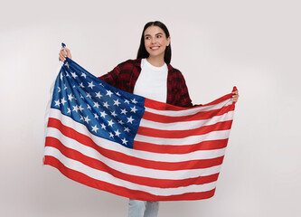 4th of July - Independence Day of USA. Happy woman with American flag on white background