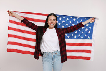 4th of July - Independence Day of USA. Happy woman with American flag on white background