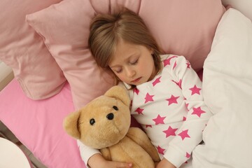 Little girl snoring while sleeping in bed, above view