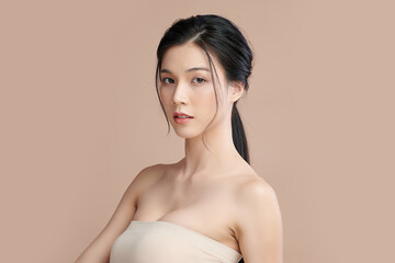 Obraz premium Beautiful young asian woman with clean fresh skin on beige background, Face care, Facial treatment, Cosmetology, beauty and spa, Asian women portrait.