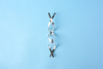 DNA molecular chain model made of metal on light blue background, top view
