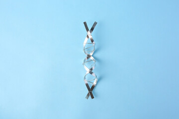 DNA molecular chain model made of metal on light blue background, top view
