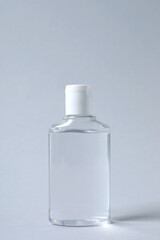Bottle of cosmetic product on light grey background