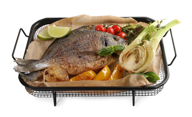 Delicious roasted dorado fish with vegetables, herbs and lime isolated on white, above view
