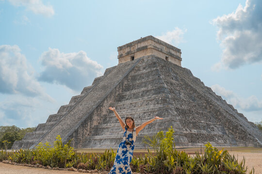 young woman visits one of the most beautiful pyramids in the world, the pyramid of chichen itza in mexico with her camera