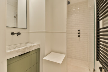 a modern bathroom with white tiles and green cabinetd vanity in the shower stall is next to the sink basin