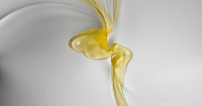 Slow Motion The swirling of mixture of white and yellow liquid cream.
