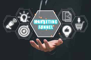Marketing funnel concept, Business person hand holding marketing funnel icon on virtual screen.