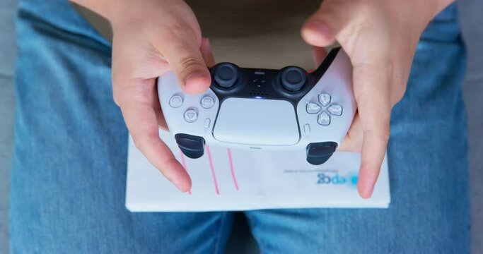 Close-up hands hold in game joystick turn off press buttons pull out cord throw out knees lies stack envelopes payment bills notification debts. Gambler struggles gambling addiction turns game console