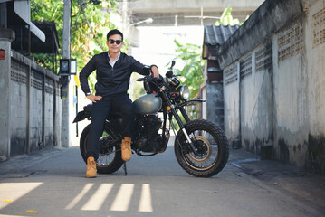 Asian man motorbike in black leather jacket travel rider trip. Handsome Men wear sunglass outdoor lifestyle freedom rider. Men trendy hipster cool person. Young asian man hobby ride with motor bike