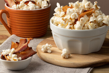 Salty popcorn with bacon on the table.