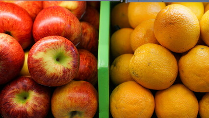 red apples and oranges side by side in the shop and market. Contrast color concept
