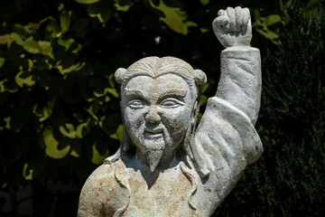 Obraz premium Statue in a garden at the Wat Suthat Buddhist Temple in Bangkok