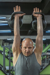 Naklejka premium Male athlete lifts weights in the gym