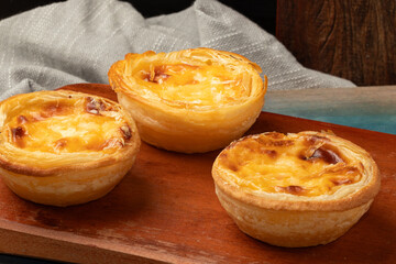 Custard tart on cutting board.
