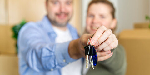 Couple showing keys to new apartment. real estate mortgage, loan concept. moving in new house....